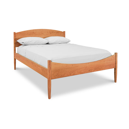 Vermont Shaker Moon Bed by Maple Corner Woodworks showcasing an eco-friendly wooden frame with elegantly curved headboard and footboard.