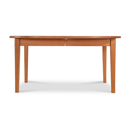 Vermont Shaker Oval Extension Dining Table by Maple Corner Woodworks with an oval top and tapering legs, crafted from sustainably harvested wood.
