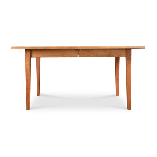 Vermont Shaker Rectangular Extension Dining Table by Maple Corner Woodworks, crafted from sustainably harvested wood, showcasing a simple design with four sturdy legs.