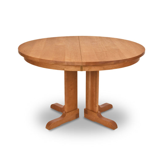Vermont Traditions Split Pedestal Round Extension Table by Lyndon Furniture, featuring a classic pedestal base and smooth round top in natural wood finish.